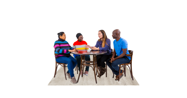 Four people sitting at a table talking.