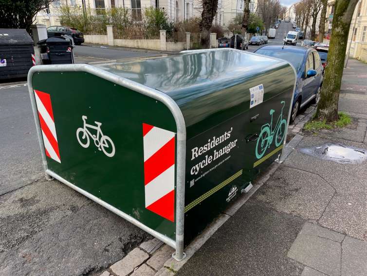 Cycle hangar on on street. Hangar has reflective side panel stickers.